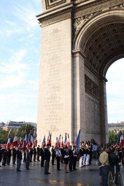 parade-underneath-arc-de-triomphe-paris