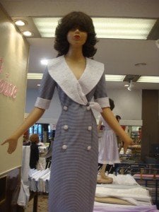 Barbie doll-like dummies model miniature dresses at Paris fabric store