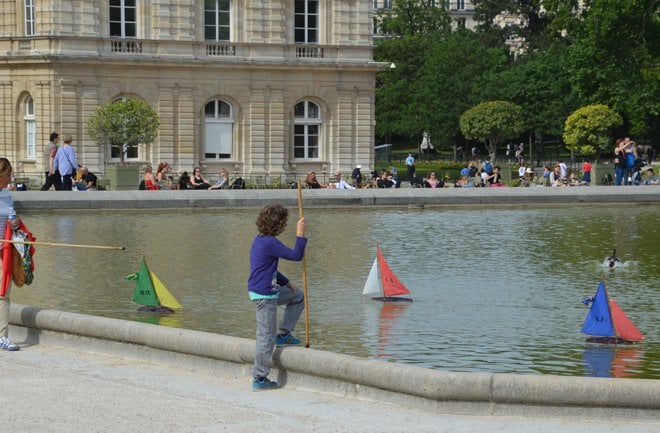 Children playing with rented remote controlled boats at the Jardin du Luxembourg.