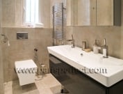 Contemporary bathroom with dark lacquered cabinets