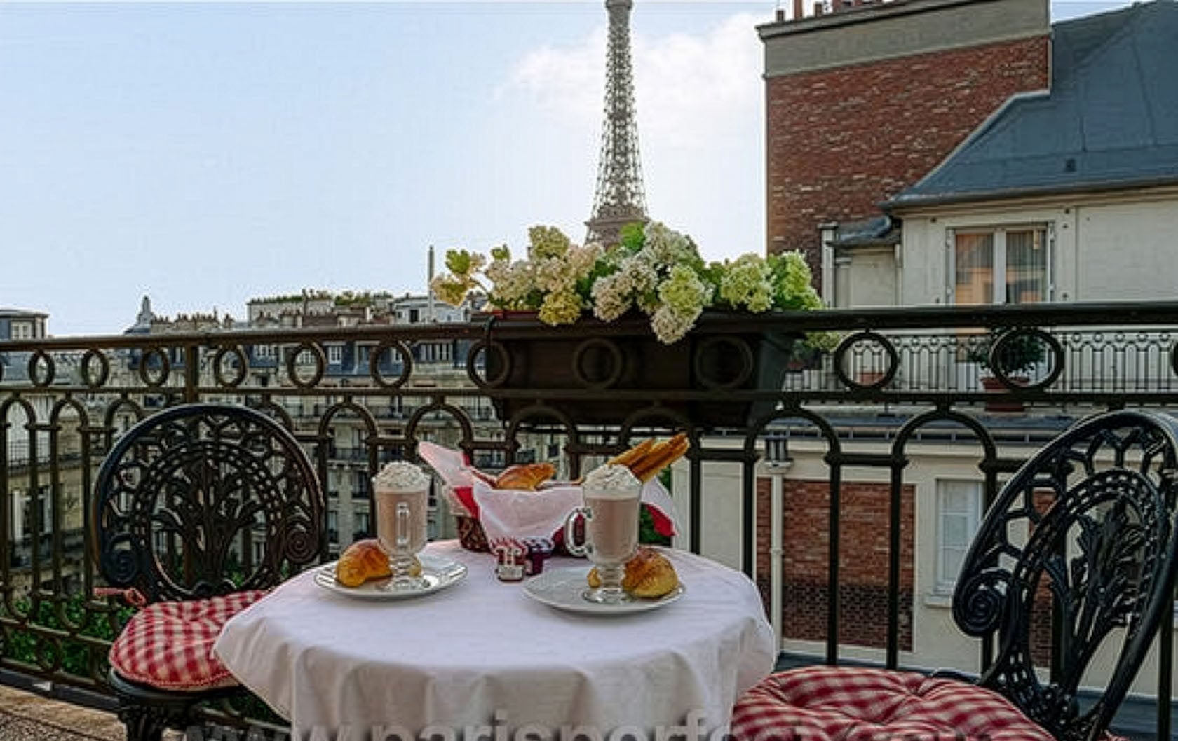 A Paris vacation dream - cafe au lait on a balcony with gorgeous Eiffel Tower views!