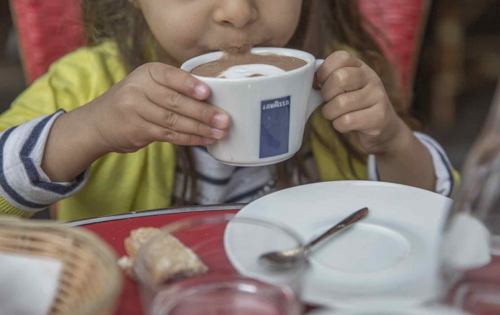 Learn These Essential French Phrases Before Your Trip to Paris by Paris Perfect Child drinking hot chocolate in Paris