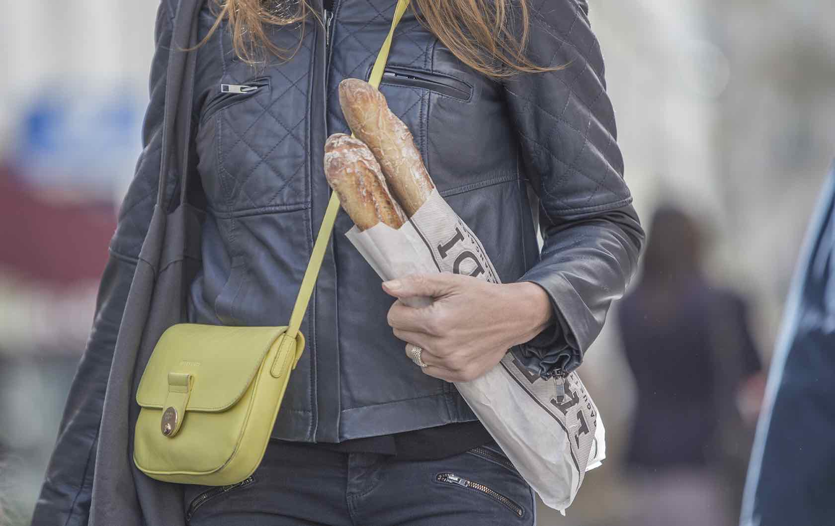 Paris tips woman with baguette