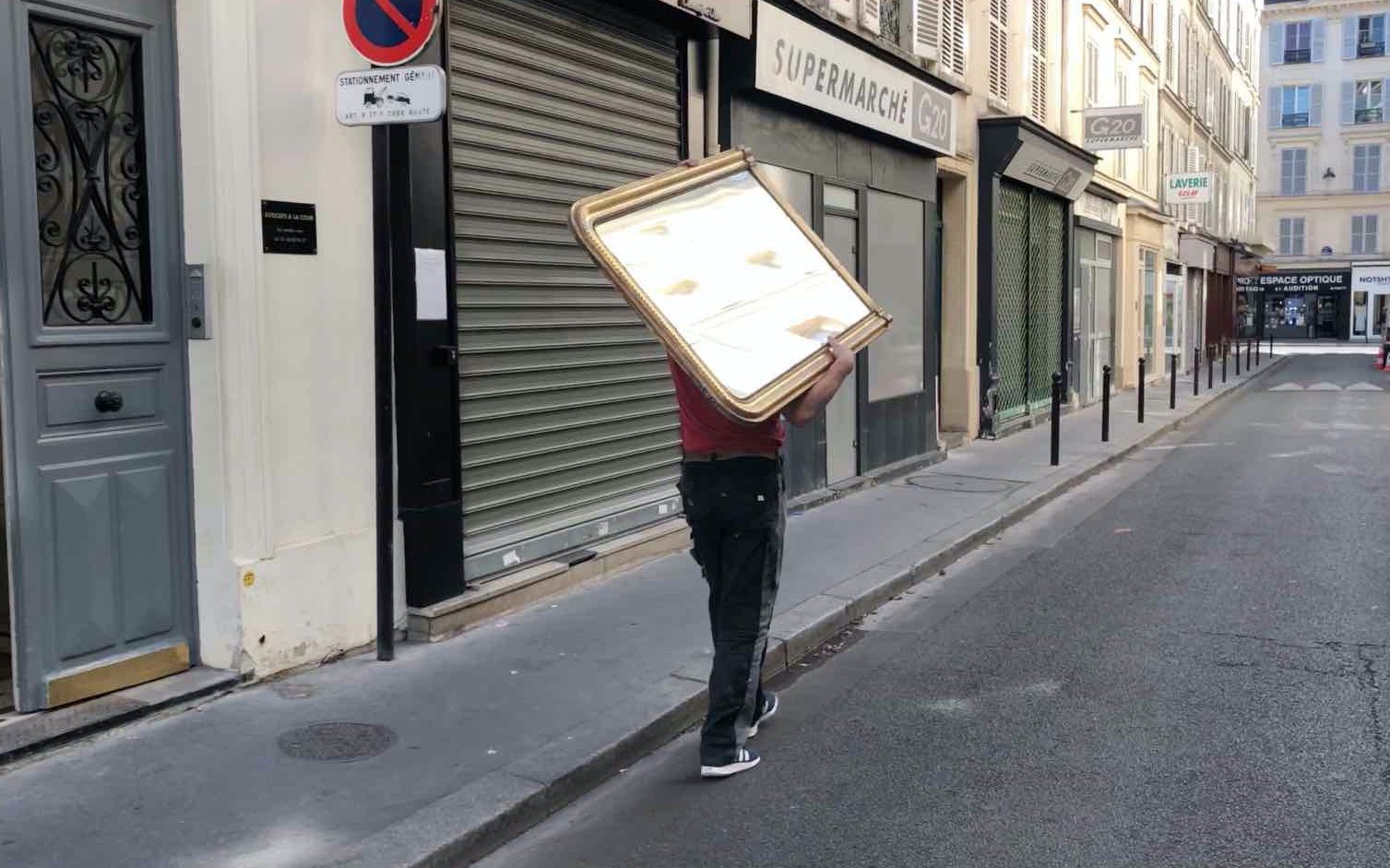 man carrying a mirror