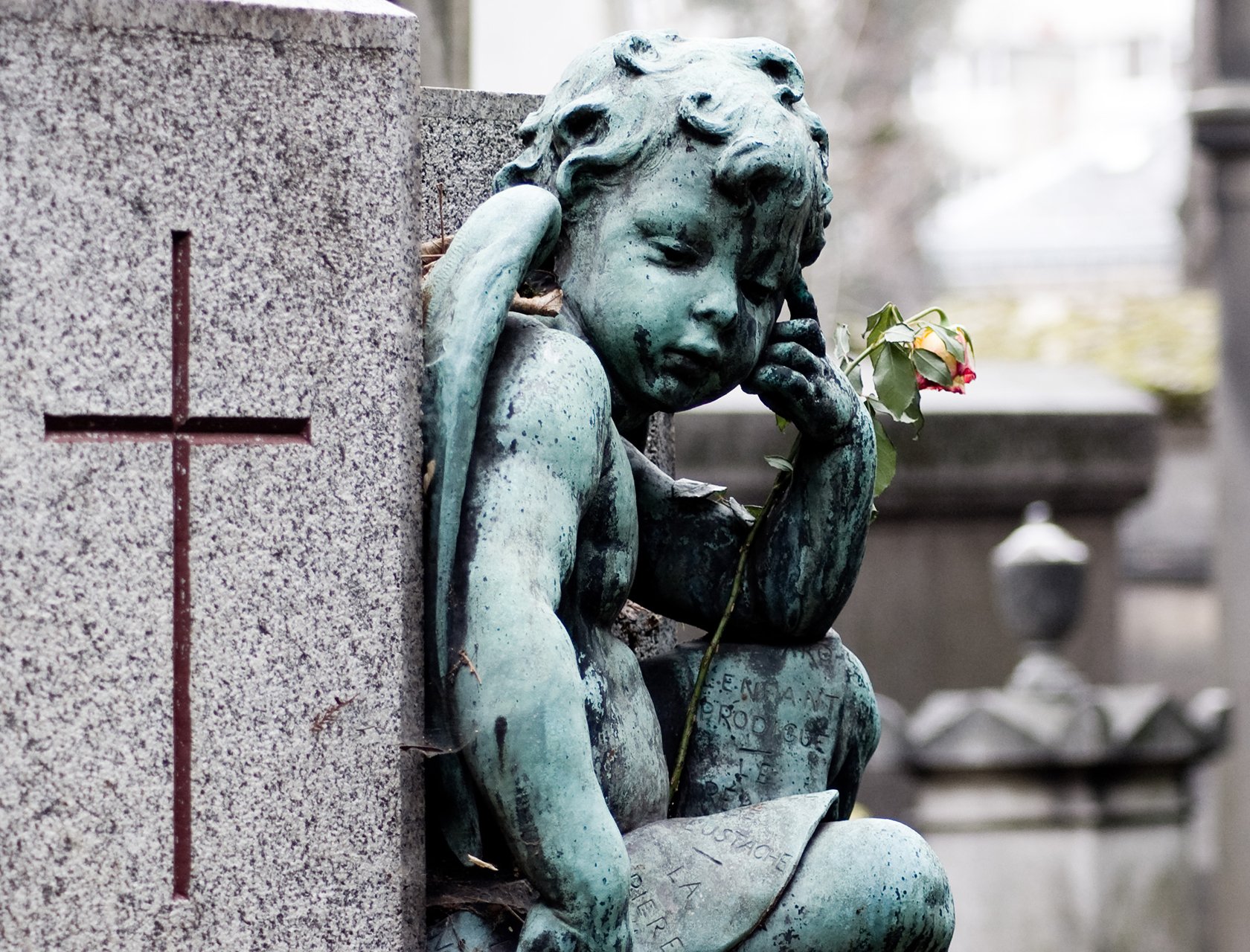 Cherub statue in Père Lachaise Cemetery in Paris