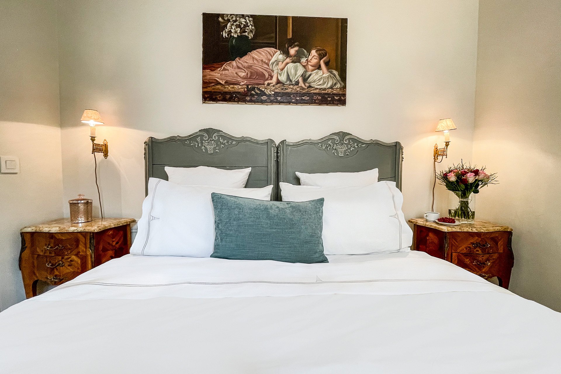 Antique nightstands add character to the bedroom.